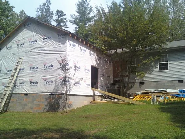 Tyvek wrapped gable on a new room addition beside an existing home in Southold